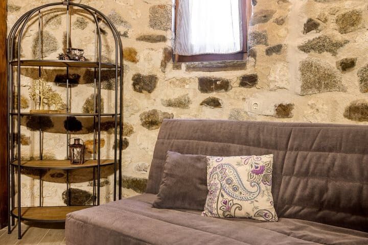 Interior detail of the restored windmill — stone walls and decorative shelf